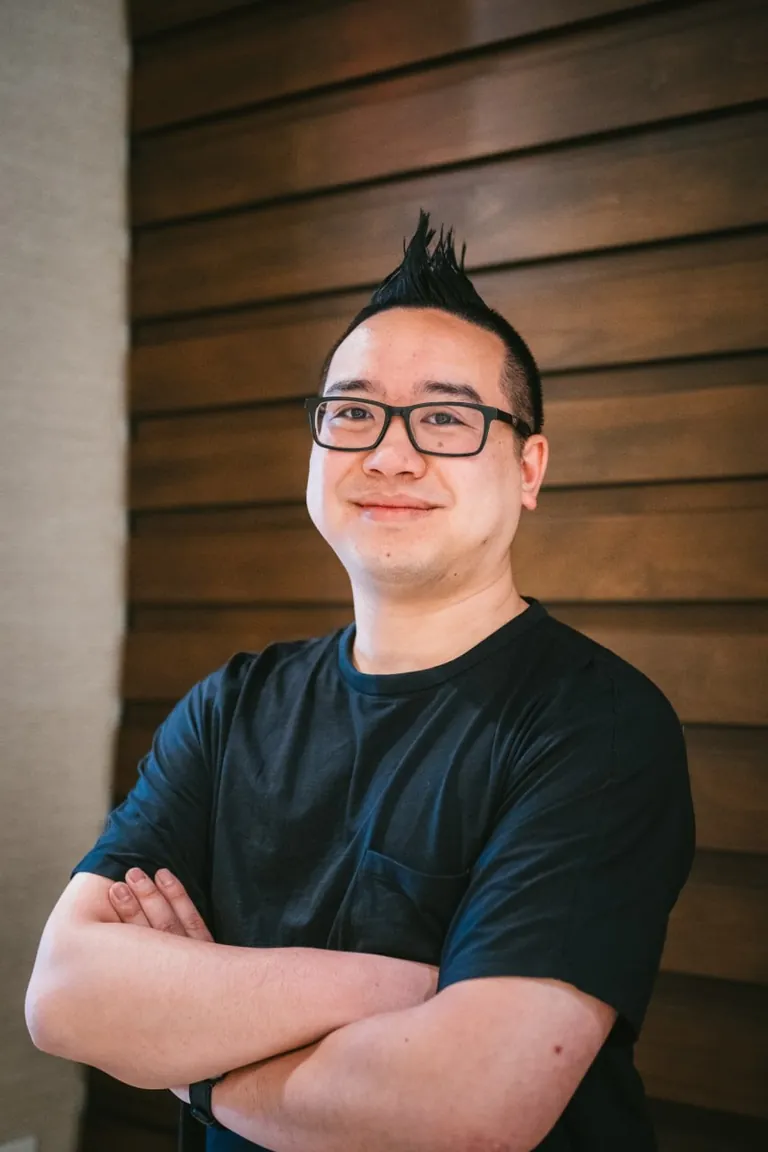 Coach Tony Le, former UC Berkeley external admissions reader and founder of egelloC, arms crossed, smiling